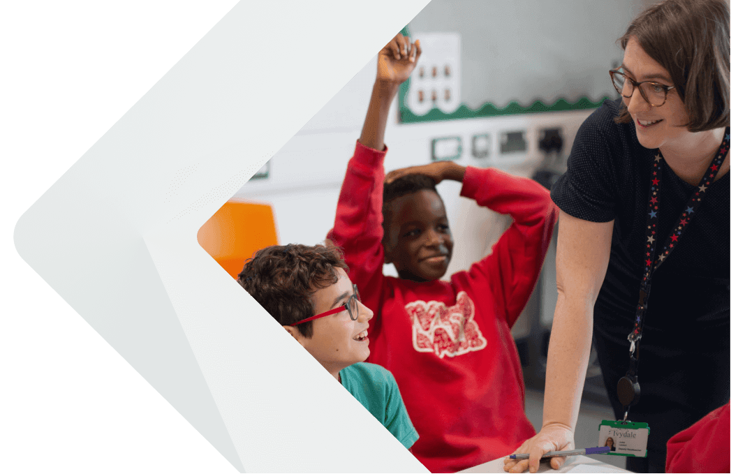 A teacher and two students in a classroom.