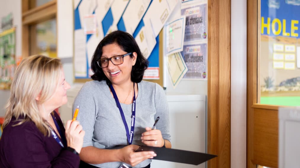 Two teachers laughing together